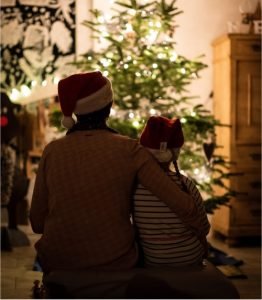 family in front of Christmas tree