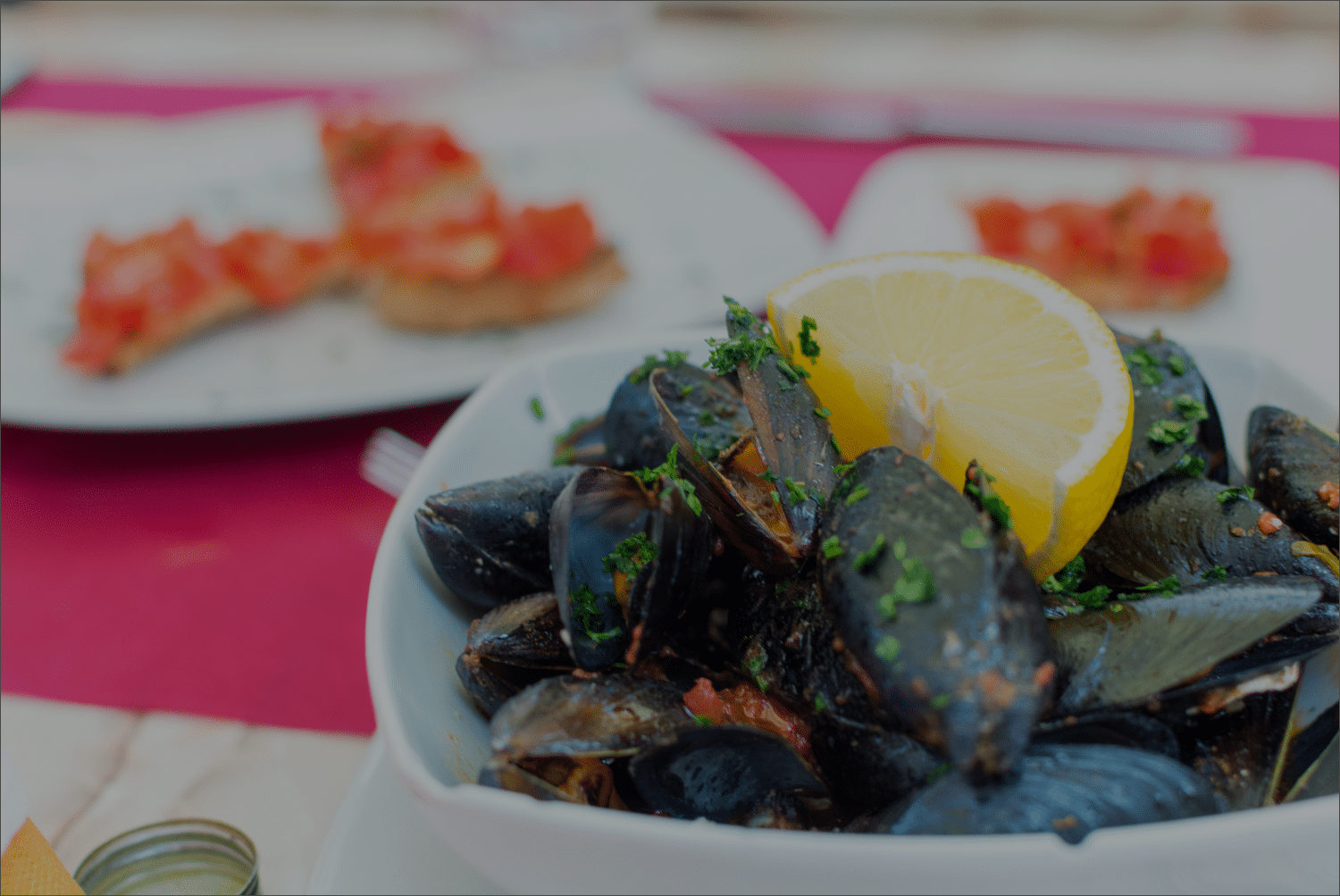 A bowl of mussels on a table